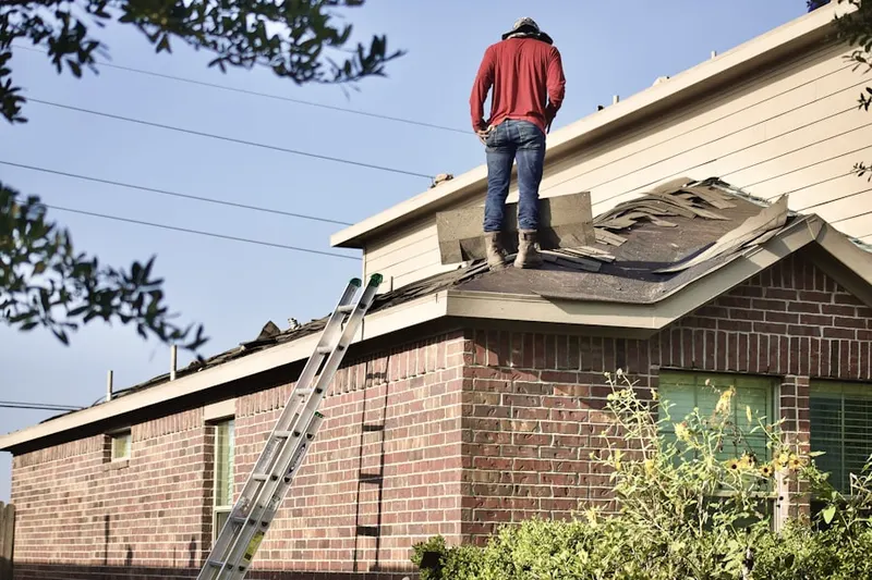Professional roofer working on a residential roof in Coastal Ridge